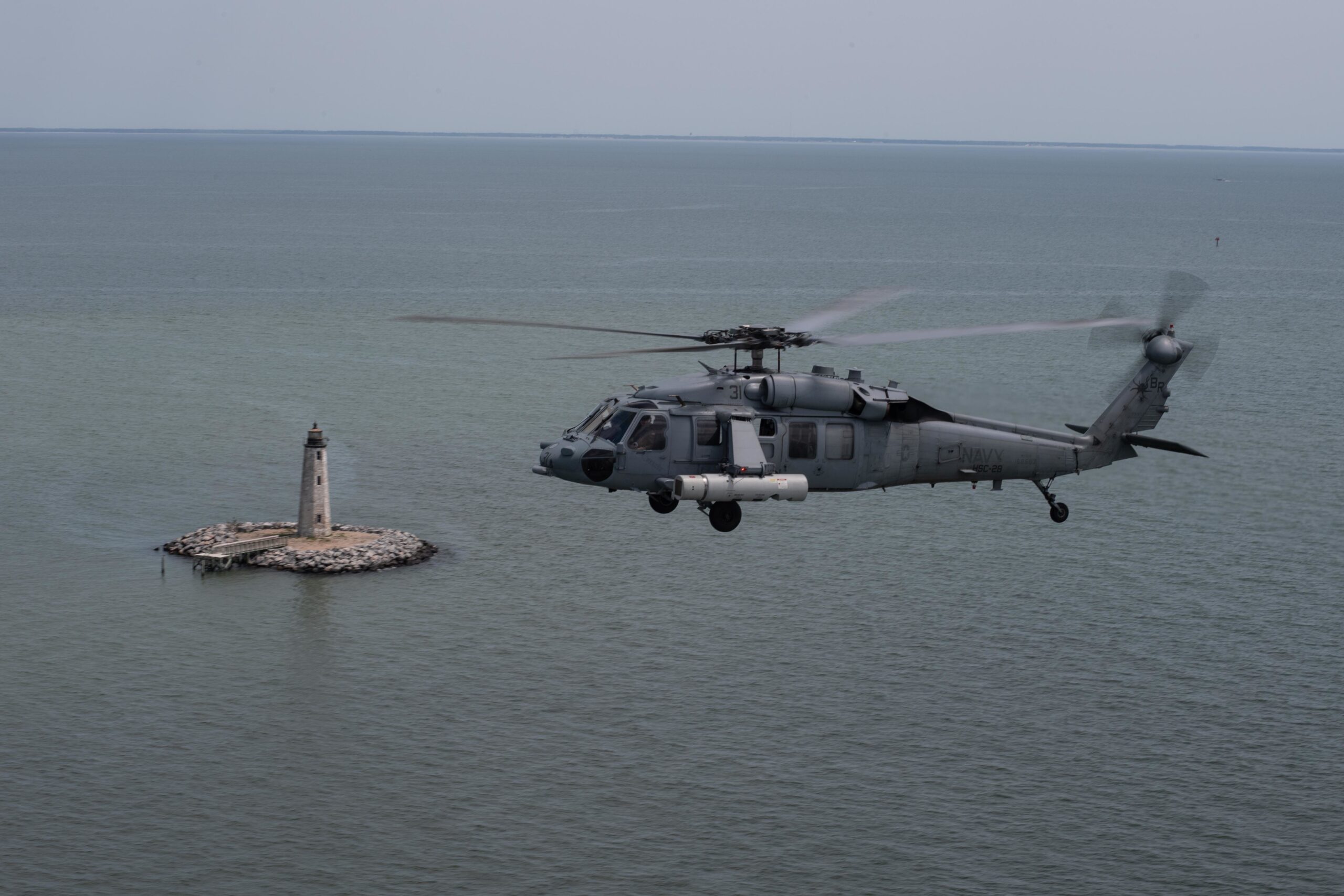 An MH-60S Sea Hawk, attached to the Dragon Whales of Helicopter Sea Combat Squadron (HSC) 28, equipped with its Airborne Laser Mine Detection System (ALMDS), flies over the Chesapeake Bay, April 29, 2020. Operated from the MH-60S Sea Hawk, ALMDS provides rapid wide-area reconnaissance and assessment of mine threats in littoral zones, confined straits, and choke points. HSC-28 is stationed in Norfolk, Virginia. (U.S. Navy photo by Mass Communication Specialist 3rd Class Rebekah M. Rinckey)