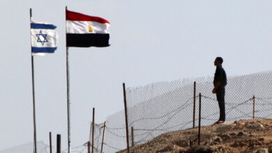 An Egyptian soldier stands guard at the Taba crossing between Egypt and Israel