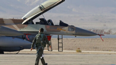 An Israeli Air Force pilot walks to his F-16 fighter jet during the "Blue Flag" multinational air defense exercise at the Ovda air force base