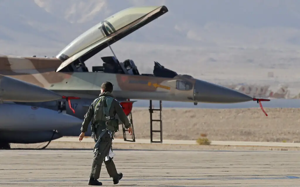 An Israeli Air Force pilot walks to his F-16 fighter jet during the "Blue Flag" multinational air defense exercise at the Ovda air force base