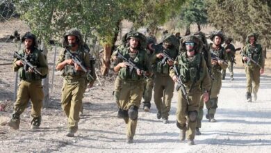 Israeli troops patrol at an undisclosed location along the border with the Gaza Strip