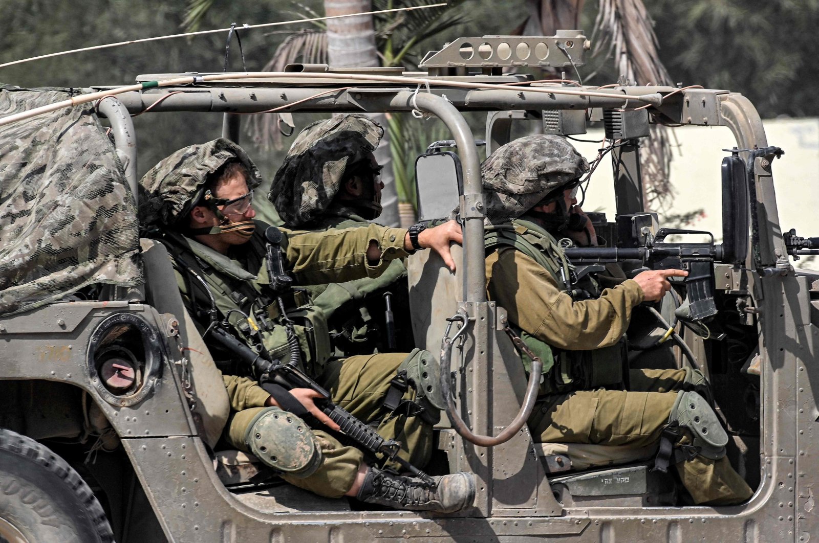 Israeli army soldiers sit in a humvee at a checkpoint near the border with the Gaza Strip, Sderot, Israel
