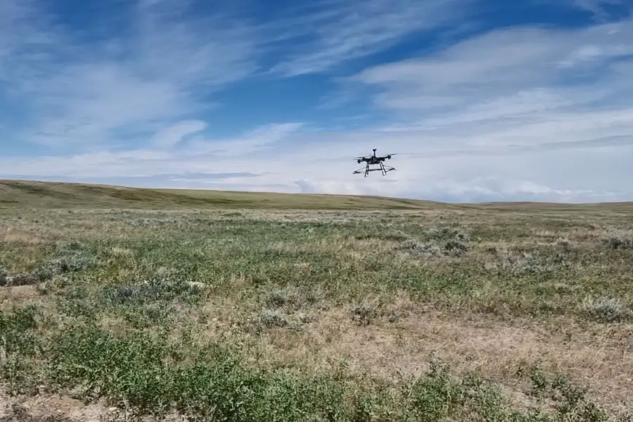 Drone flying above a field.