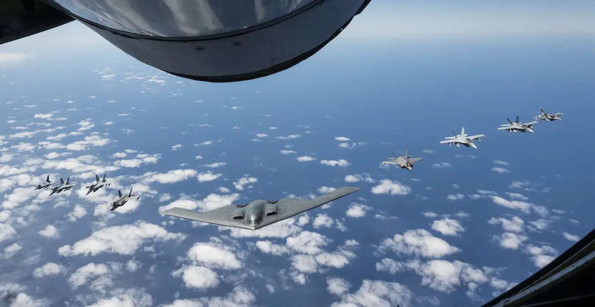 A US Air Force B-2 Spirit flies in formation with two Royal Australian Air Force F-35A Lightning IIs, two RAAF F/A-18F Super Hornets, two RAAF EA-18 Growlers, and two US Air Force F-16C Aggressors