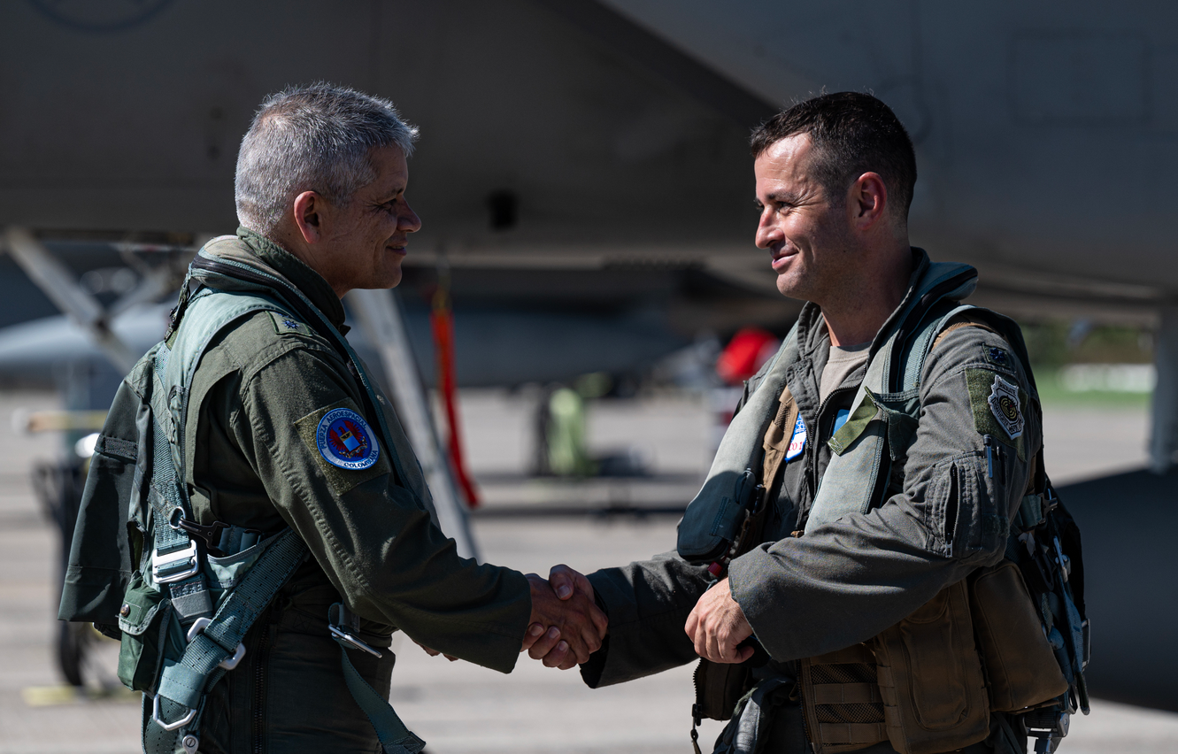 Colombia Aerospace Force (COLAF) Maj. Gen. Carlos Fernando Silva Rueda (left), Second Commander and Chief of Staff of the COLAF, shakes hands with U.S. Air Force Lt. Col. Daniel Schiller (right), 125th Fighter Wing chief of safety, Florida Air National Guard, after a training sortie during exercise Relampago VIII in Palanquero, Colombia.