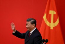 China's President Xi Jinping waves after introducing the members of the Chinese Communist Party's new Politburo Standing Committee, 2022