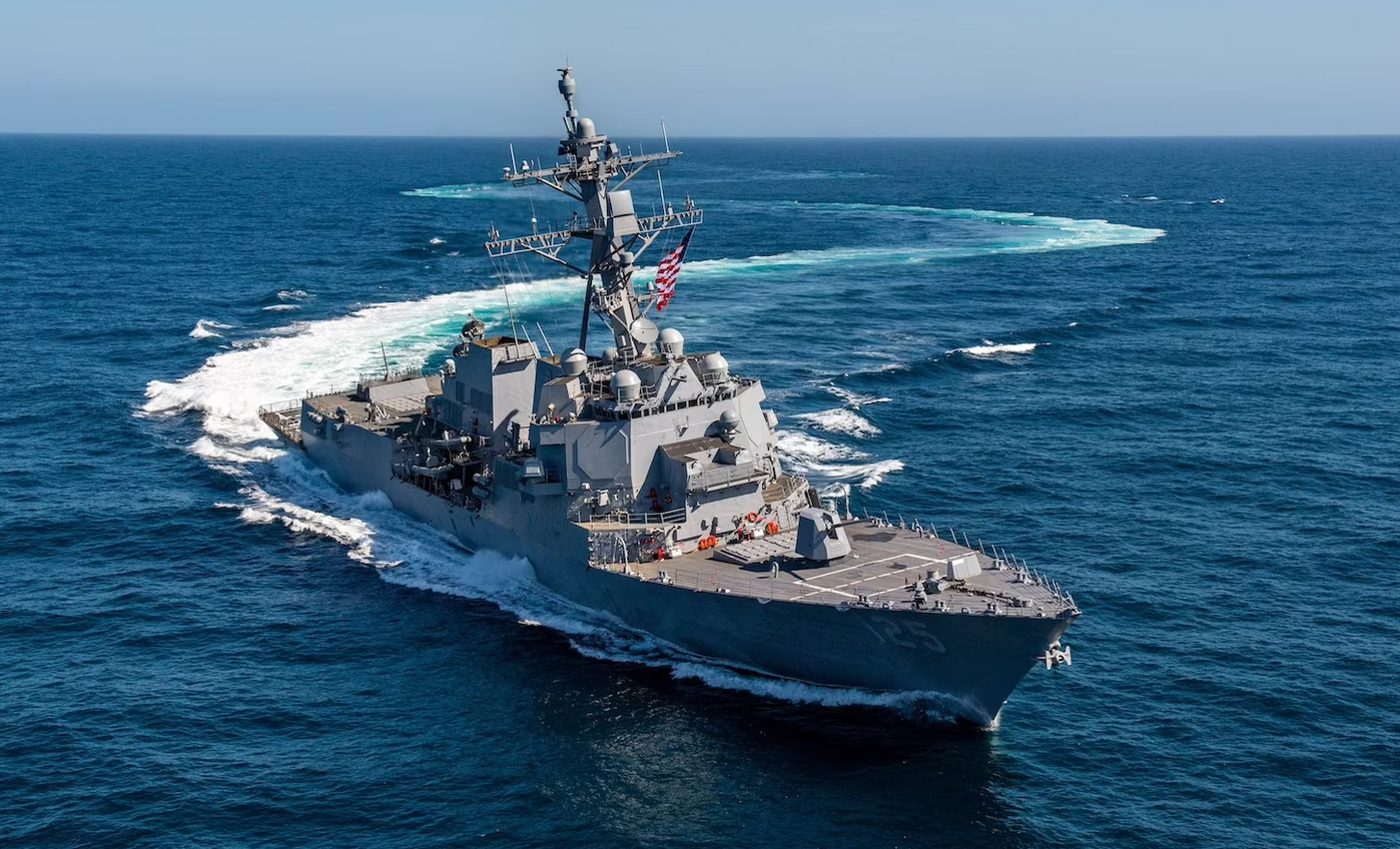 USS Jack H Lucas (DDG-125), the US Navy's first Flight III variant Arleigh Burke-class destroyer, is seen sailing the waters. A plain blue sky serves as the background.