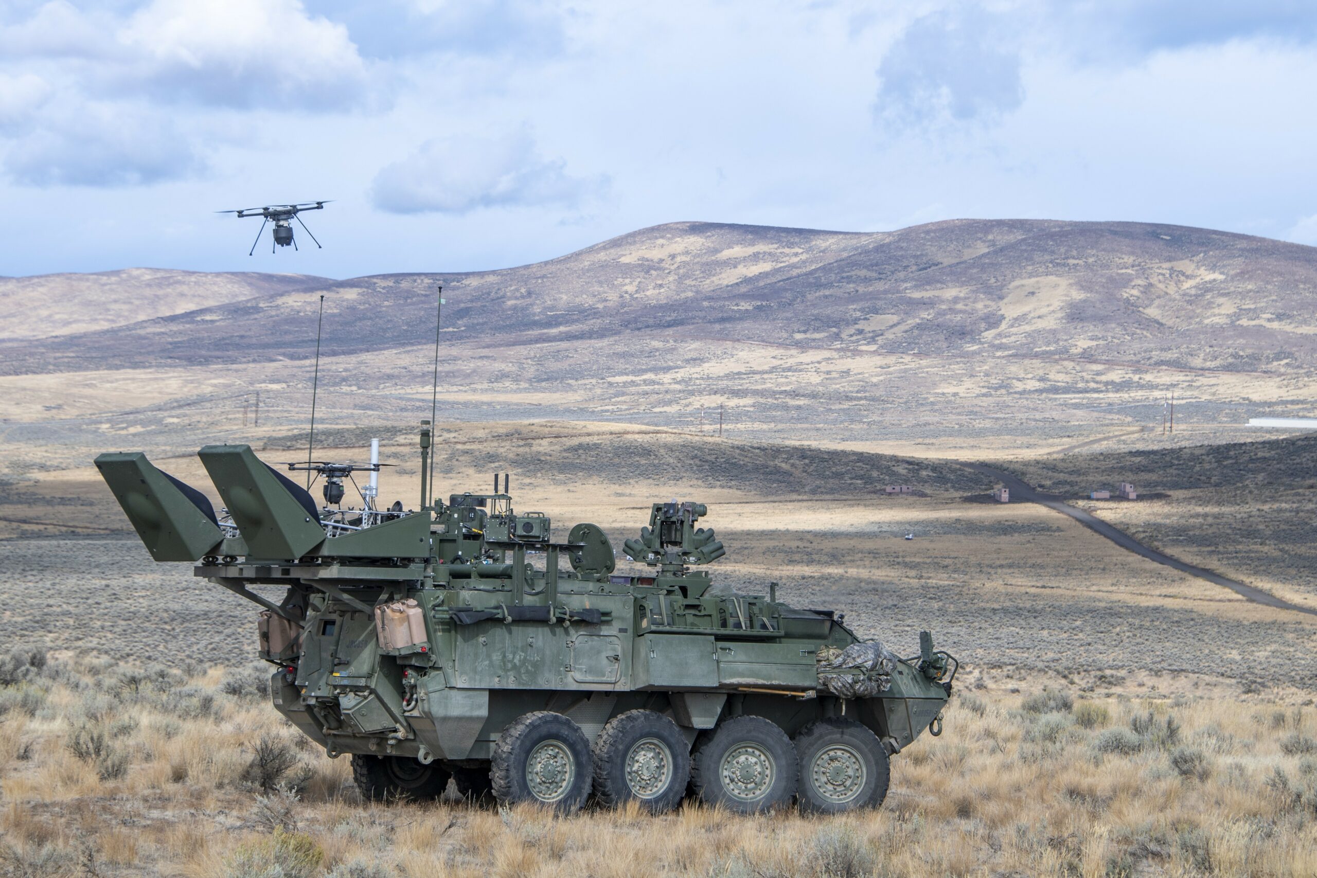 Test participants from the Reconnaissance (RECCE) Platoon, Headquarters and Headquarters Company, 23rd Brigade Engineer Battalion, launch a Small Unmanned Aerial System (sUAS) to conduct remote detection of biological warfare agents, while conducting stand-off scanning with the Sensor Suite Upgrade (SSU) on an M1135 variant Stryker — the Army’s high-speed, high-mobility, armored carrier. (U.S. Army photo by Tad Browning)
