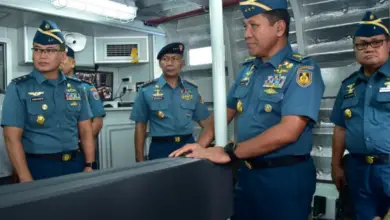Five Indonesian officers stand inside the new Special Mission Combat Boat.