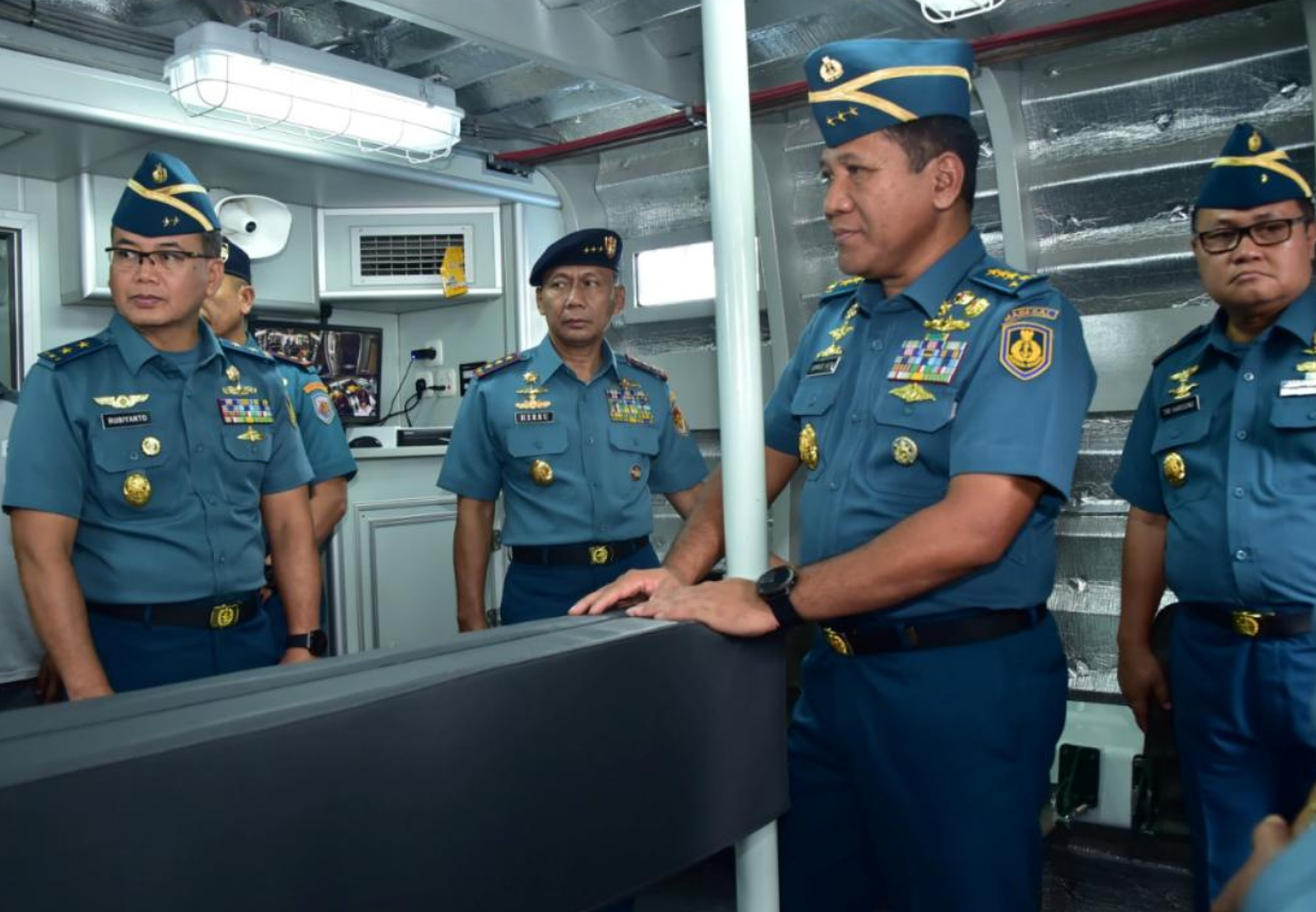 Five Indonesian officers stand inside the new Special Mission Combat Boat.