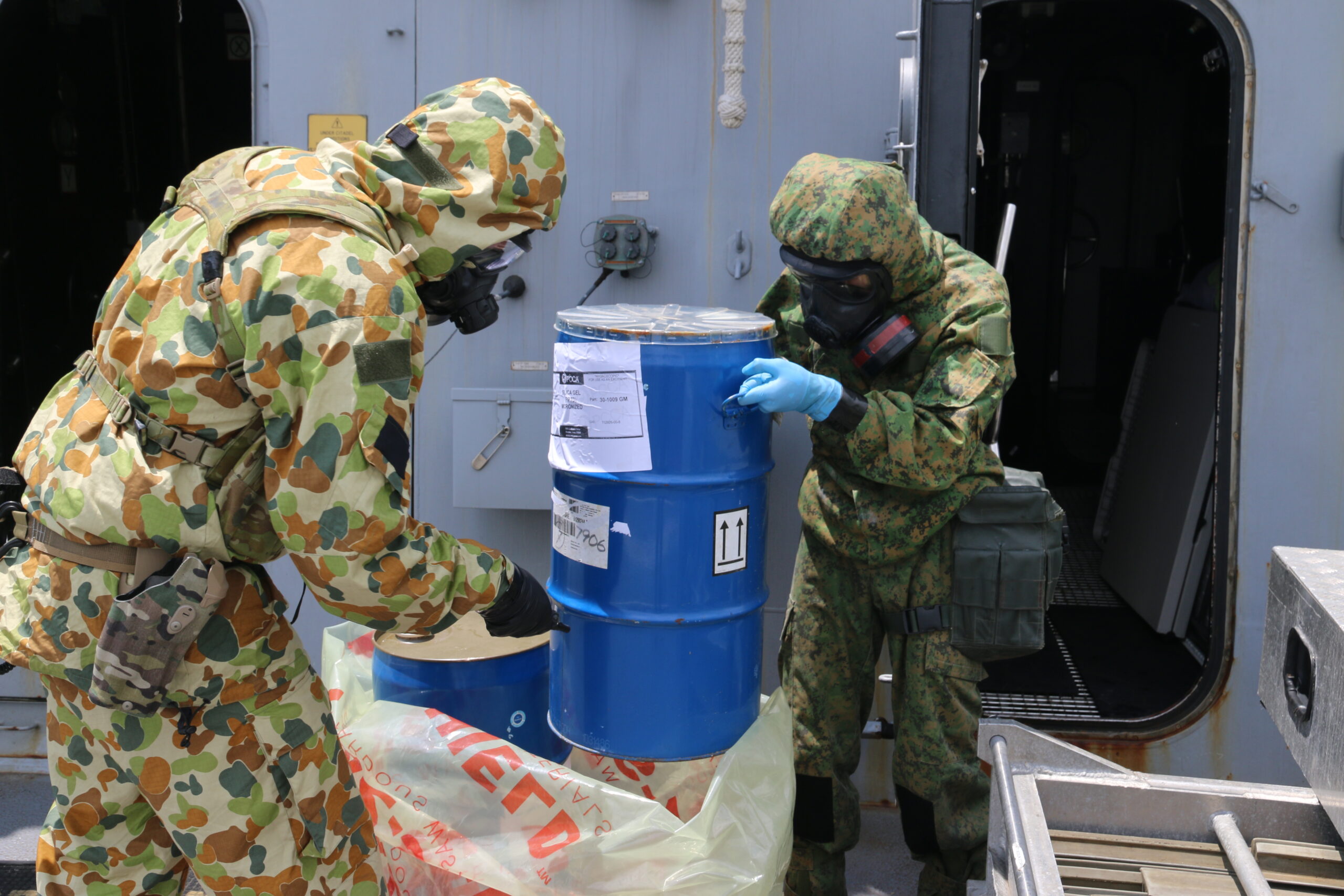 Australian and Singaporean defence personnel conduct CBRN training on board HMAS Brisbane whilst alongside in Sembawang *** Local Caption *** Australian Army special operations force soldiers from the Special Operations Engineer Regiment (SOER) joined 36th and 39th Battalion, Singapore Combat Engineers, specialists for counter-CBRNE (chemical, biological, radiological, nuclear and high-yield explosives) training in Singapore as part of Indo-Pacific Endeavour 2023. The Australian Army and Singapore Army combat engineers conducted training together in Singapore and on the Royal Australian Navy destroyer HMAS Brisbane to share skills and further enhance interoperability. SOER counter-CBRNE specialist soldiers are highly trained and responsible for developing Australian Defence Force doctrine and ensuring the ADF is equipped to meet current and future needs. SOER is an Australian Army special operations force unit within Special Forces Group providing the Australian Government with unique technical capabilities in support of the national interest.