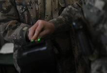 An Army soldier demonstrates a biometrics device during Vice Adm. Robert S. Harward's visit to Zaranj, Afghanistan, Jan 6. The commanding officer of Combined Joint Interagency Task Force 435 toured a provincial prison and the Iran/Afghanistan border crossing.