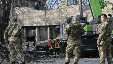 Rescuers clear debris at a partially destroyed building after an air strike in the town of Rzhyshchiv, in the Kyiv region on March 22 amid the Russian invasion of Ukraine