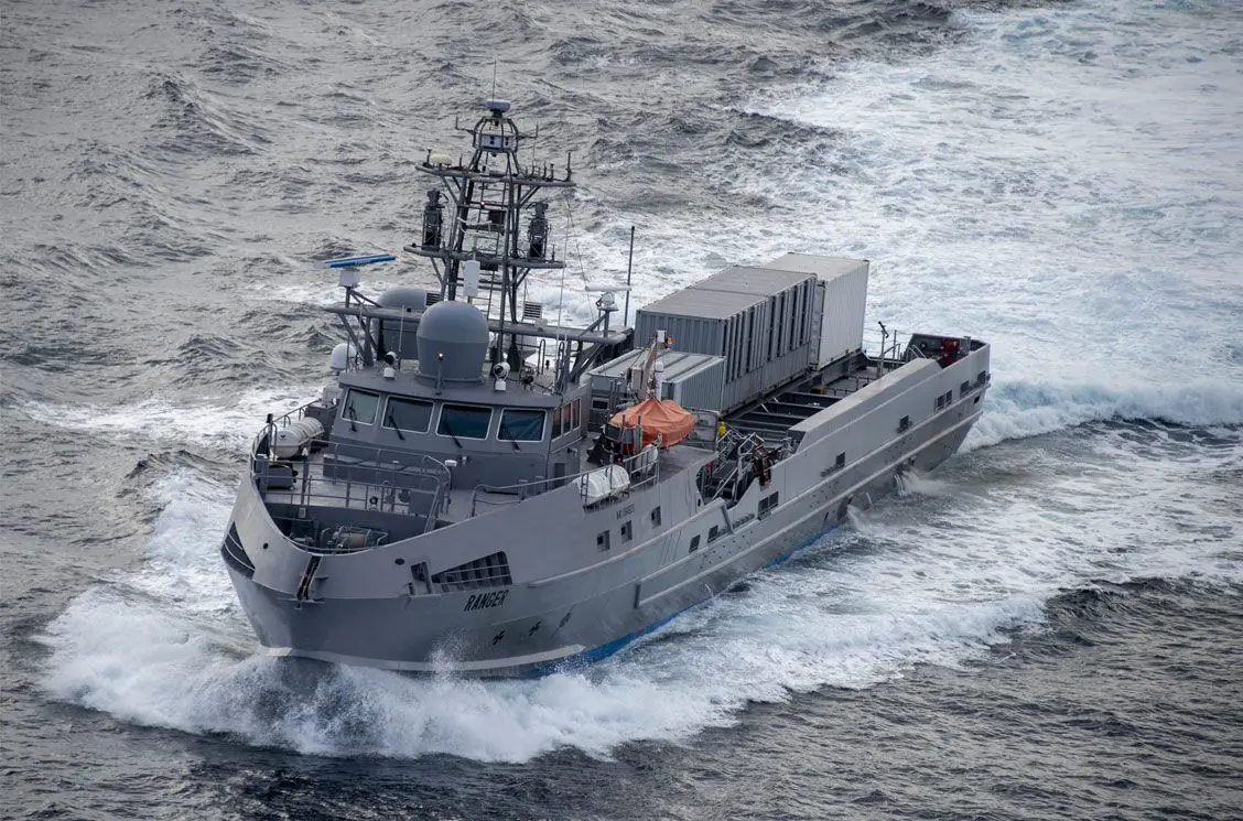 Ranger, a US Navy unmanned surface vessel, is seen sailing blue-grey waters. Its hull is painted black and the word "RANGER" is painted on its hull, close to the front.