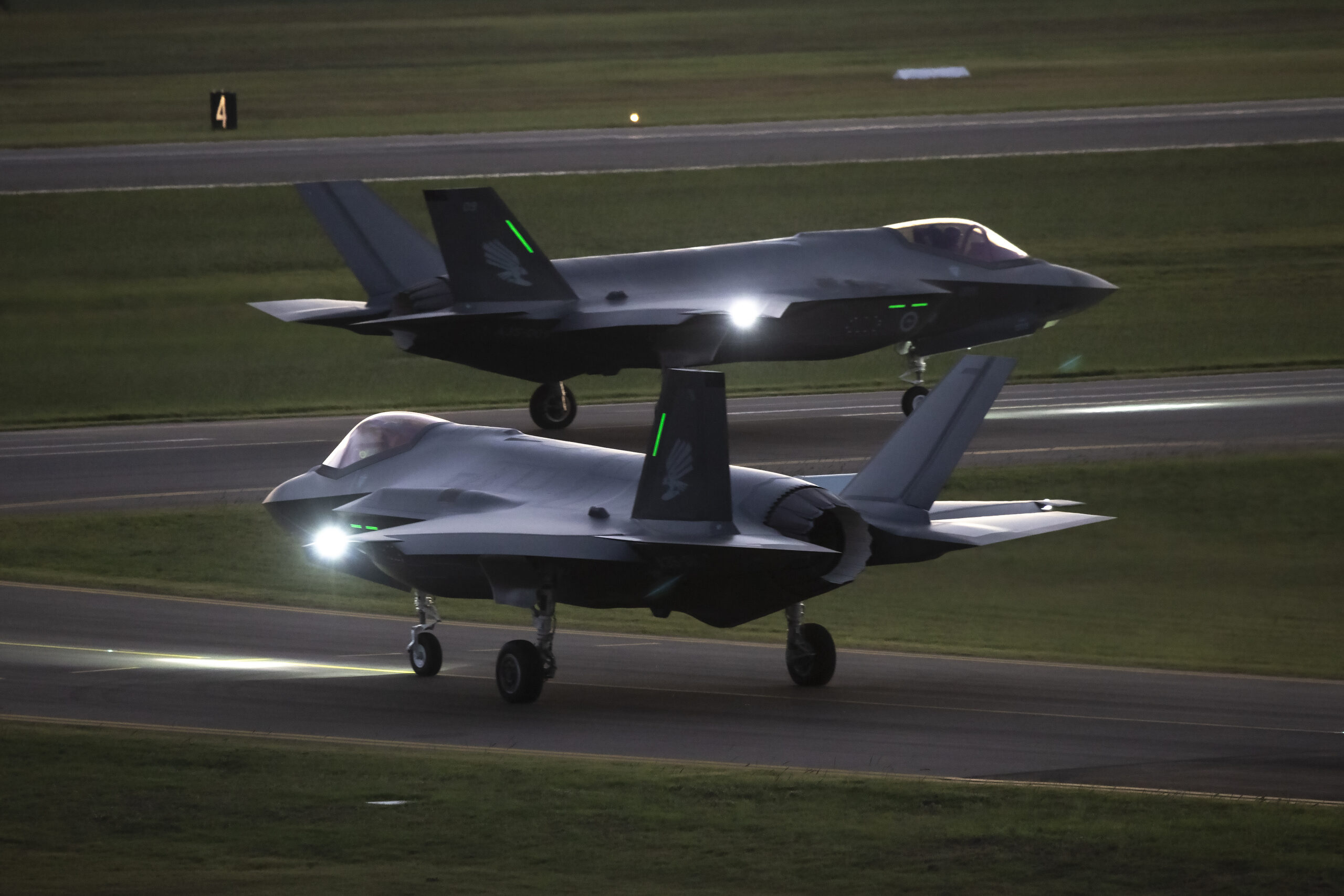 No 3 Squadron Joint Strike fighters A35-09 and A35-11 taxi out for a night sortie from RAAF Base Williamtown. *** Local Caption *** Two F-35A Joint Strike Fighter aircraft from No. 3 Squadron conducted night flying at RAAF Base Williamtown as part of pilot familiarisation training.
