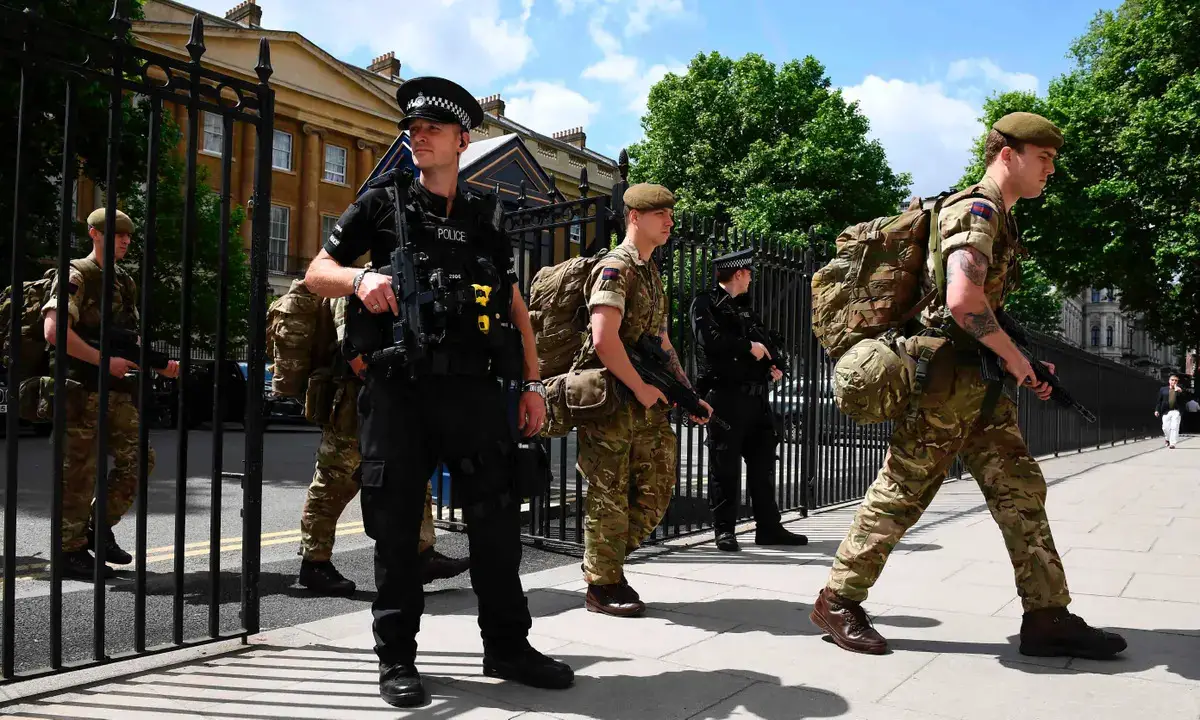 British soldiers arrive at a Ministry of Defence building near to New Scotland Yard police headquarters, London