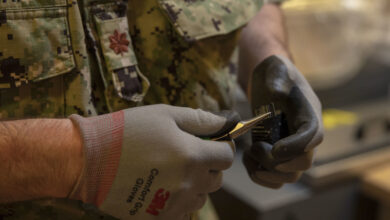 210609-N-KY668-1016 NAVAL STATION MAYPORT, Fla. (June 9, 2021) Lt. Cmdr. Jake Lunday, engineering duty officer at OPNAV N4 and additive manufacturing analyst, reviews a 3D-printed part while supporting Naval Station Mayport’s Southeast Regional Maintenance Center (SERMC). SERMC provides surface ship maintenance, modernization and technical expertise in support of the ships and facilities on base. (U.S. Navy photo by Mass Communication Specialist 3rd Class Austin Collins/Released)