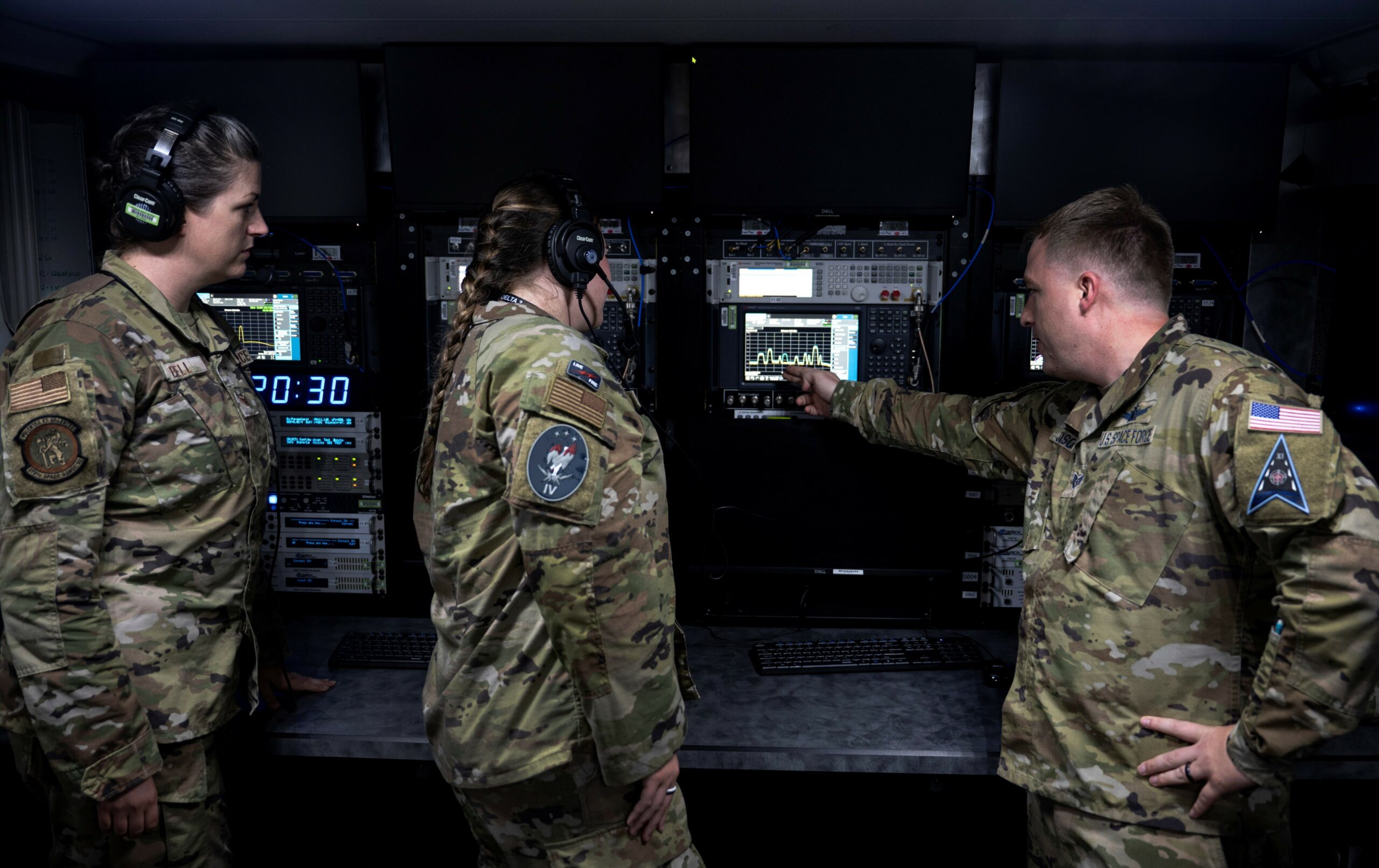 Service members from the U.S. Space Force and U.S. Air Force demonstrate the functionality of range equipment at Peterson Space Force Base, Colorado, Aug. 16, 2022. As part of a counterspace combined arms training event, two range squadrons, the U.S. Space Force’s 25th Space Range Squadron assigned to Delta 11, and the U.S. Air Force Reserve’s 379th Space Range Squadron, supported training for the USSF’s 4th Electronic Warfare Squadron and integrated an additional service partner unit for the first time. (U.S. Air Force photo by 1st Lt Charles Rivezzo)