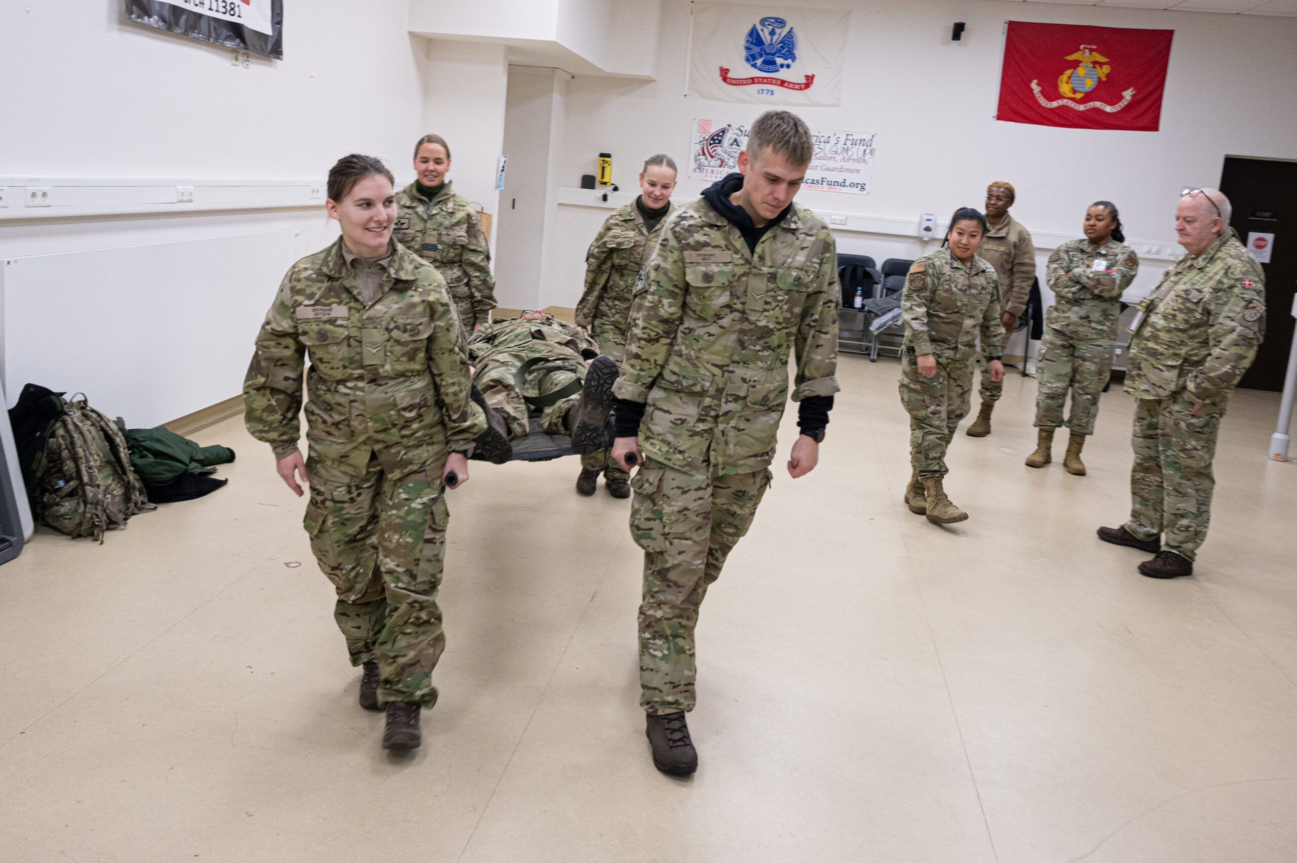 Danish medical personnel perform a litter carry as part of a demonstration at Ramstein Air Base, Germany, Nov. 29, 2023. Medical personnel from Bulgaria, Denmark, Serbia and the U.S. traveled around the Kaiserslautern Military Community where they exchanged knowledge to form best practices in their field. (U.S. Air Force photo by Senior Airman Thomas Karol)