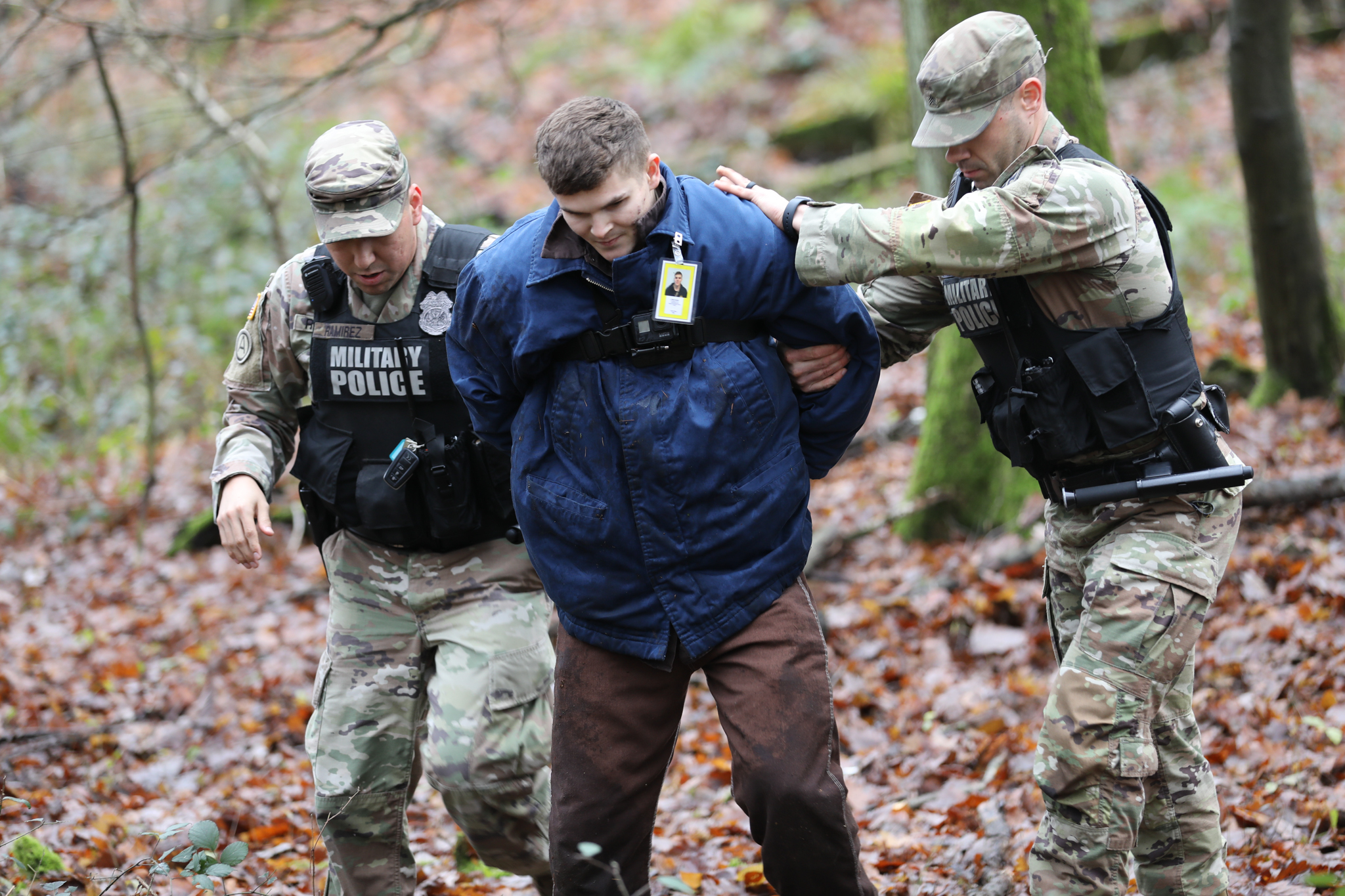 Sgt. Alexander Farnum and Staff Sgt. Renaldo Rameriez, with the 92nd Military Police Company “Rock Solid”, arrest and escort the captured escapee back towards the waiting MP vehicle during a missing prisoner emergency action plan exercise on Sembach Kaserne, Germany, on Dec. 14, 2023. The exercise was used to highlight the readiness of the facility’s military and partner organizations in the event a prisoner escapes custody.