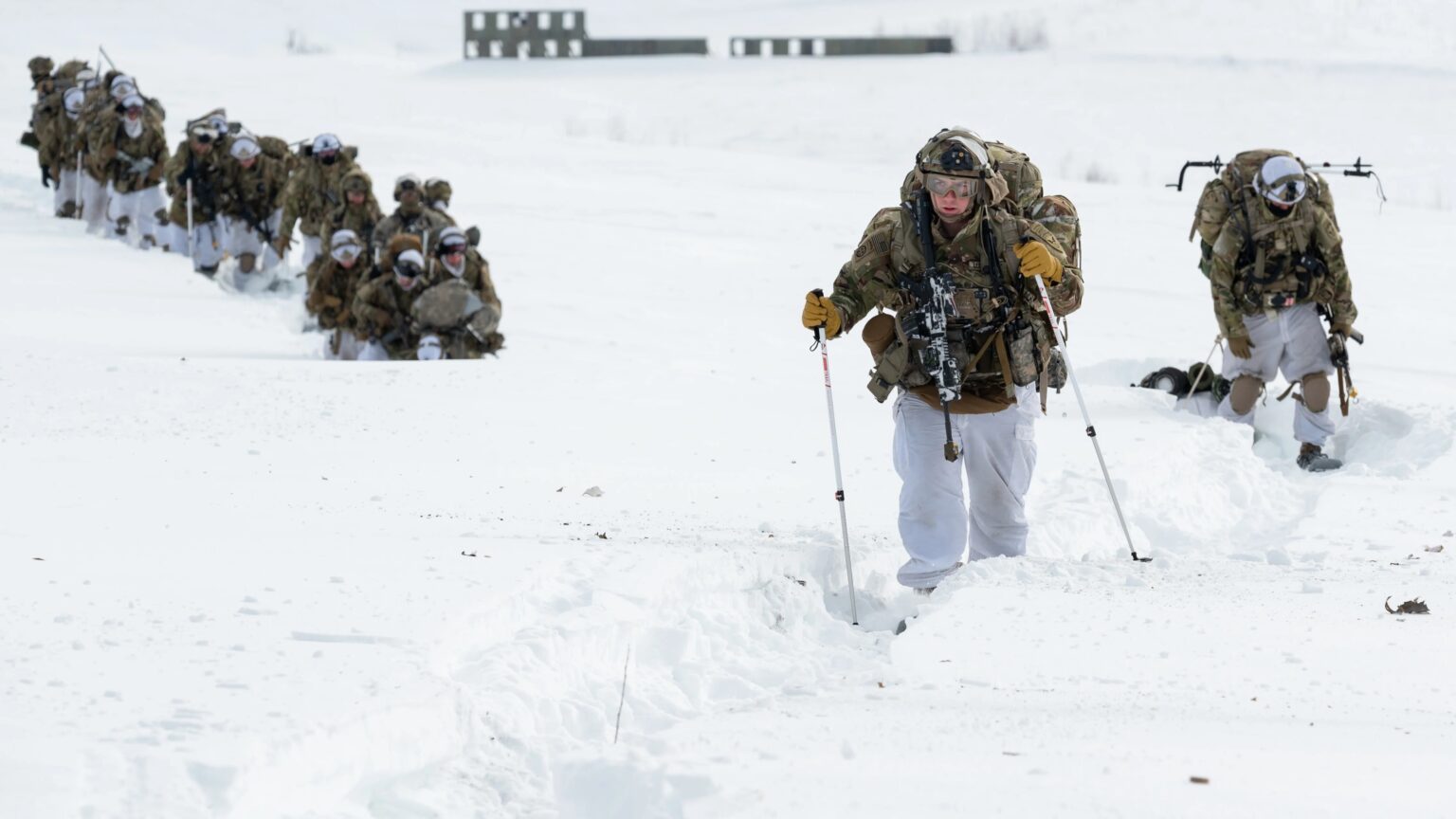 a Photo of Soldiers traversing a snowy terrain in full, cold-weather gear. Photo: Senior Airman Patrick Sullivan/US Air Force

