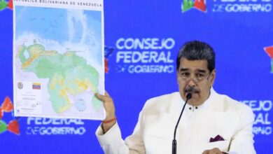 Venezuelan President Nicolas Maduro displays a map showing an oil-rich region it disputes with Guyana
