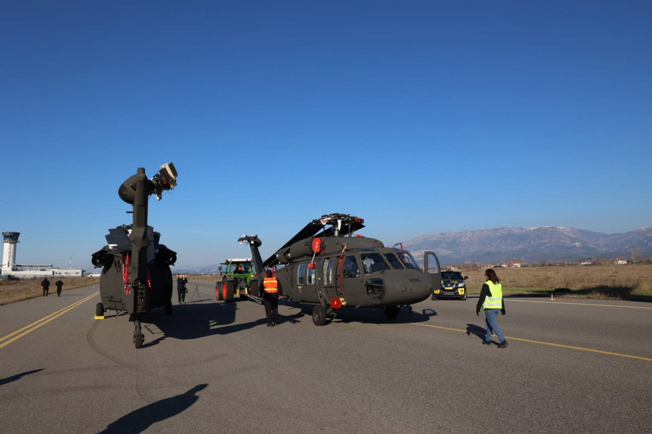 Albania's UH-60A Black Hawks, FA-666 and FA-690, are seen stationed on the ground in what appears to be a runway. All of the helicopters' blades are swooped back, suggesting that the image was taken shortly after it was delivered by the US Air Force's Boeing C-17A airlifter.
