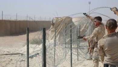 US Marine Corps combat engineers improve force protection measures by laying concertina wire at Al Asad Air Base, Iraq