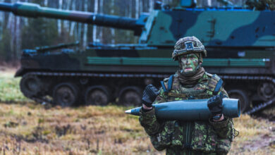 Soldier holding artillery ammunition