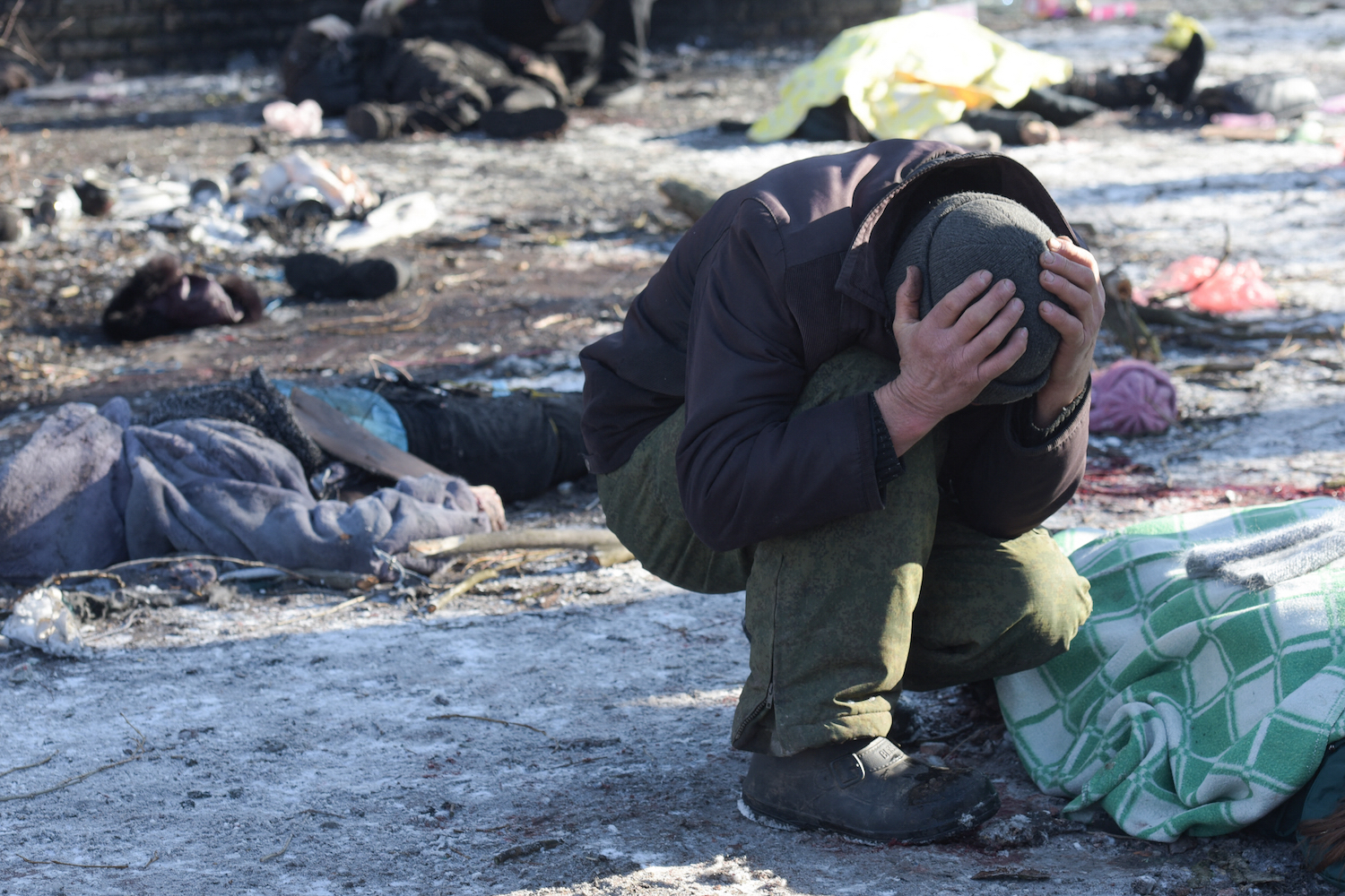 Man cries next to the body of his wife killed as a result of a missile strike in Donetsk on January 21, 2024