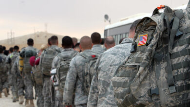 US army soldiers queue to board a plane to begin their journey home out of Iraq from the al-Asad Air Base west the capital Baghdad, November 1, 2011.