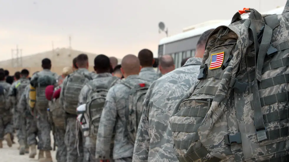 US army soldiers queue to board a plane to begin their journey home out of Iraq from the al-Asad Air Base west the capital Baghdad, November 1, 2011.