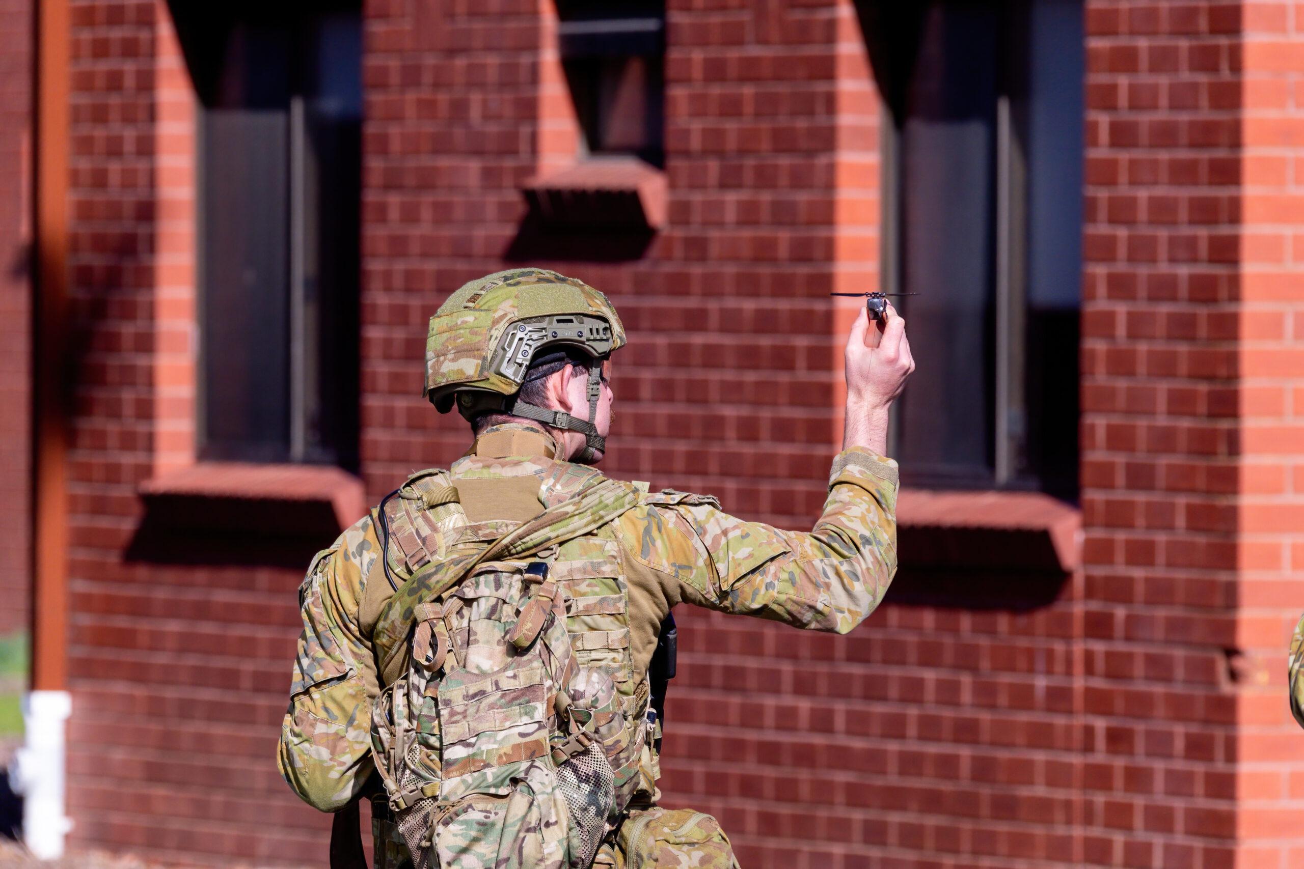 An Australian Army 4th Brigade soldier launches a Black Hornet Nano Unmanned Aerial System during urban operations training at the RAAF Williams, Point Cook on 26 May, as a part of Exercise Abel Diemen 2023. *** Local Caption *** The 4th Brigade is conducting Exercise ABEL DIEMEN across locations in Victoria and Tasmania from 19 to 28 May 2023. The 10-day training exercise provides soldiers with the opportunity to practice the types of tasks applicable in domestic and regional security operations following an ADF Call-Out under provisions for Defence Force Aid to the Civil Authority (DFACA), as well as carry out training to improve and maintain Foundation Warfighting skills.
