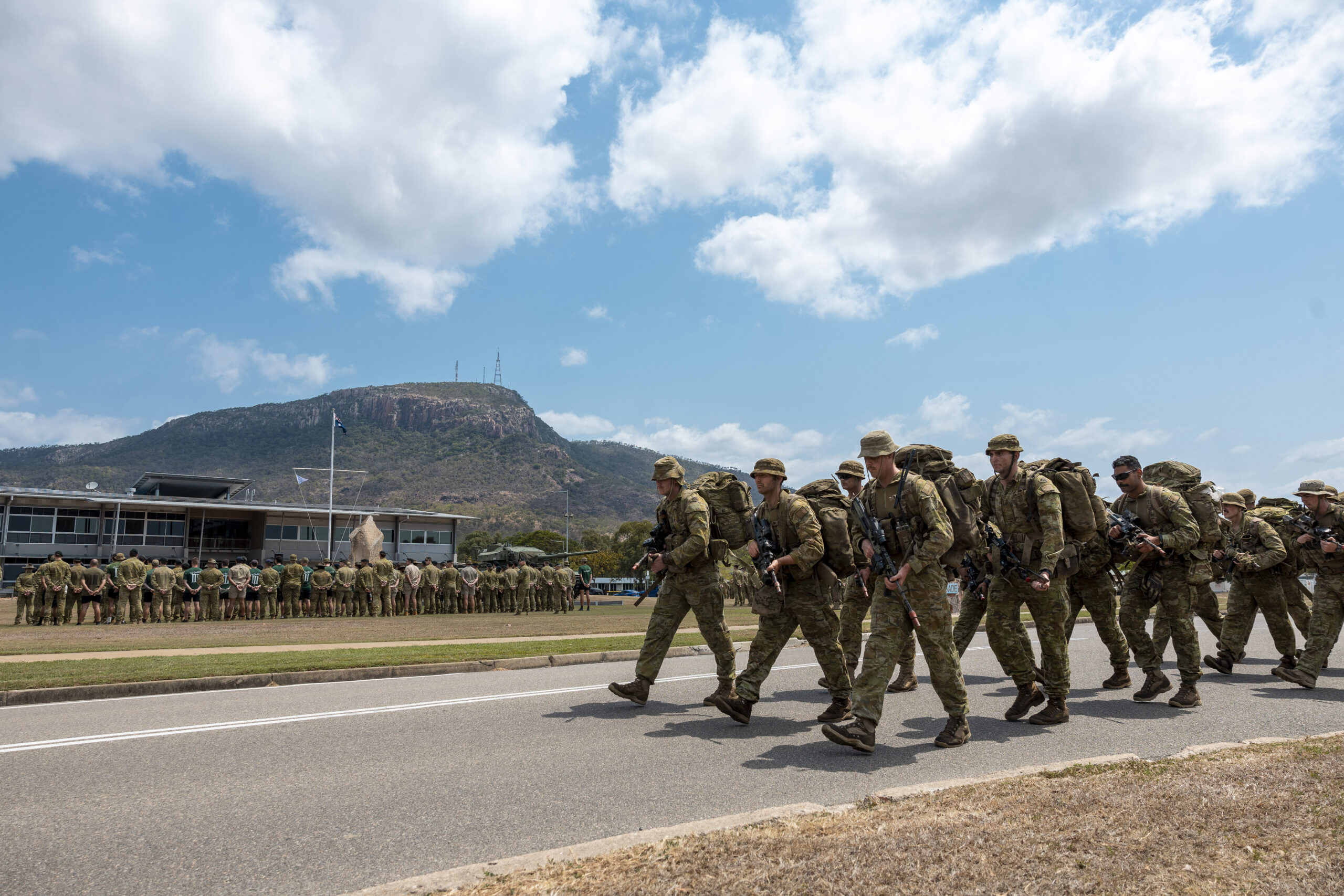 Australian Army soldiers from the 3rd Brigade march towards Brigade Headquarters as part of the 3rd Brigade Section Competition presentation at Lavarack Barracks, Townsville, Queensland. *** Local Caption *** The 3rd Brigade Section Competition was held at Lavarack Barracks, Mount Stuart Training Area and Tully Training Area, QLD, between 17-19 Oct 2023. The competition involved eight sections from within the Brigade testing themselves over a series of military skills stands. Stands included the obstacle course, marksmanship serials, casualty evacuation medical training, military flotation, section attack, section defence, communications, navigation, obstacle deduction and all arms call for fire with artillery assets.