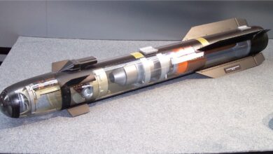A model of a Hellfire AGM-114R2 missile is seen on display. Parts of its body is transparent, showcasing its inner parts and mechanisms.