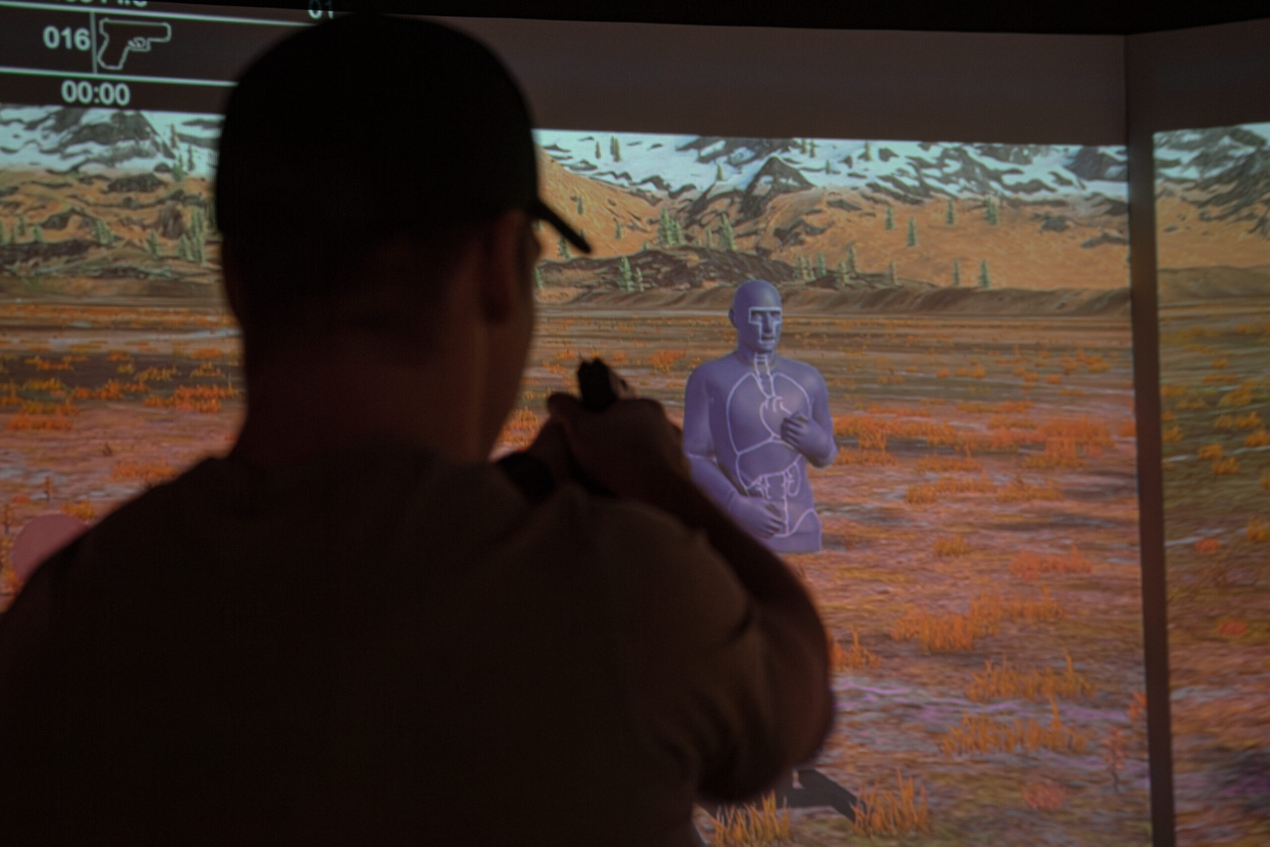 A Green Beret with 10th Special Forces Group (Airborne) fires at a target in the VirTra simulator on Fort Carson, Colorado, Feb. 2, 2024. The VirTra simulator features technology that can present different shooting scenarios, environments and targets to better help its users sharpen their shooting skills while providing realistic training. (U.S. Army photo by Sgt. David Cordova)