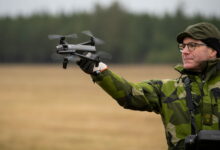 Personnel deploys Parrot drone by hand