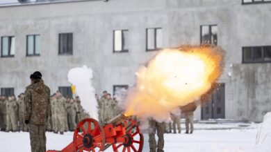 Soldiers fire cannon to mark the launch of a new military campus in Rokantiškės