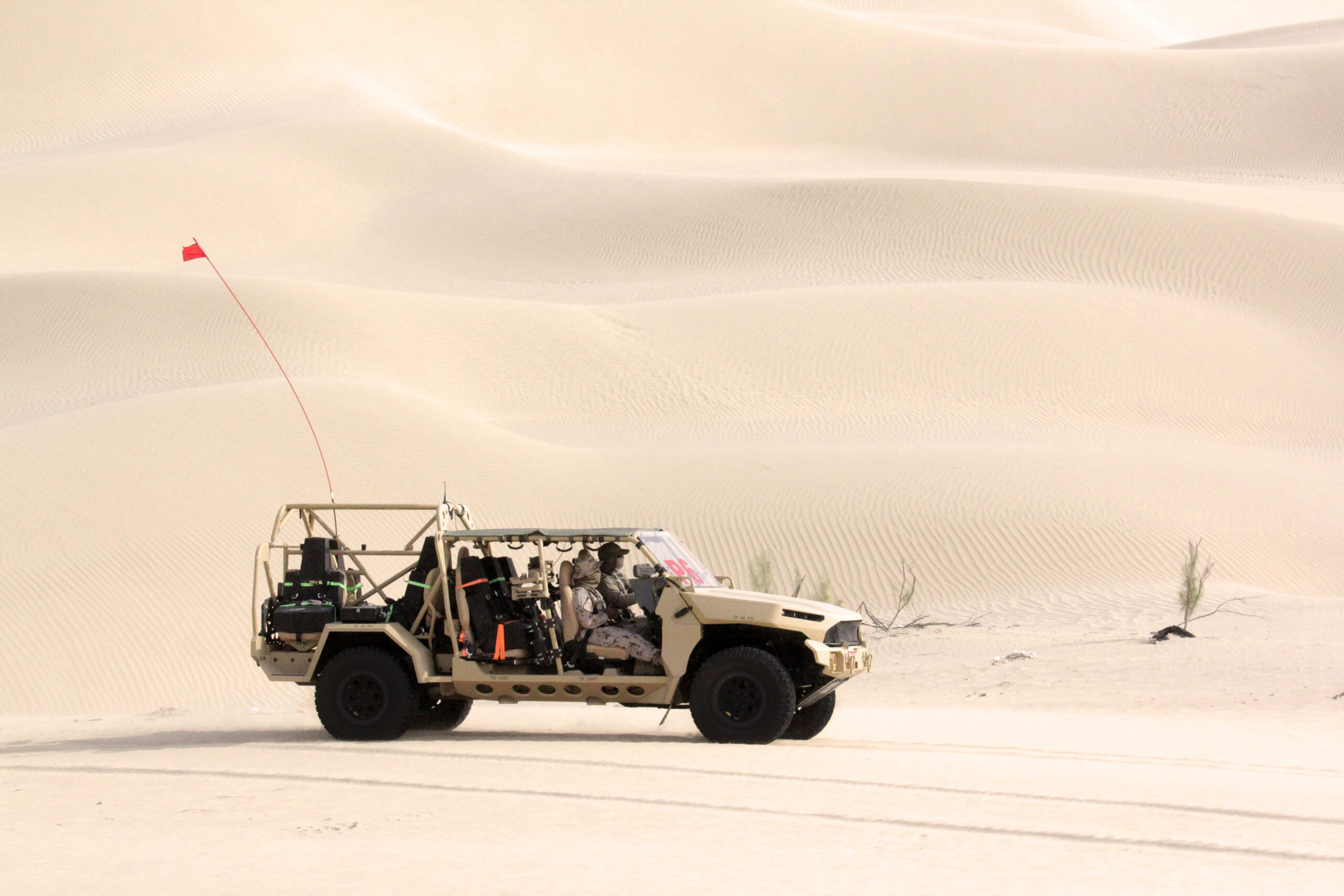 Side view of GM Defense’s Infantry Squad Vehicle driving on sand at UAE Armed Forces Summer Trials