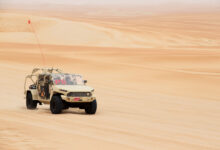 Front 3/4 view of GM Defense’s Infantry Squad Vehicle driving on sand at UAE Armed Forces Summer Trials