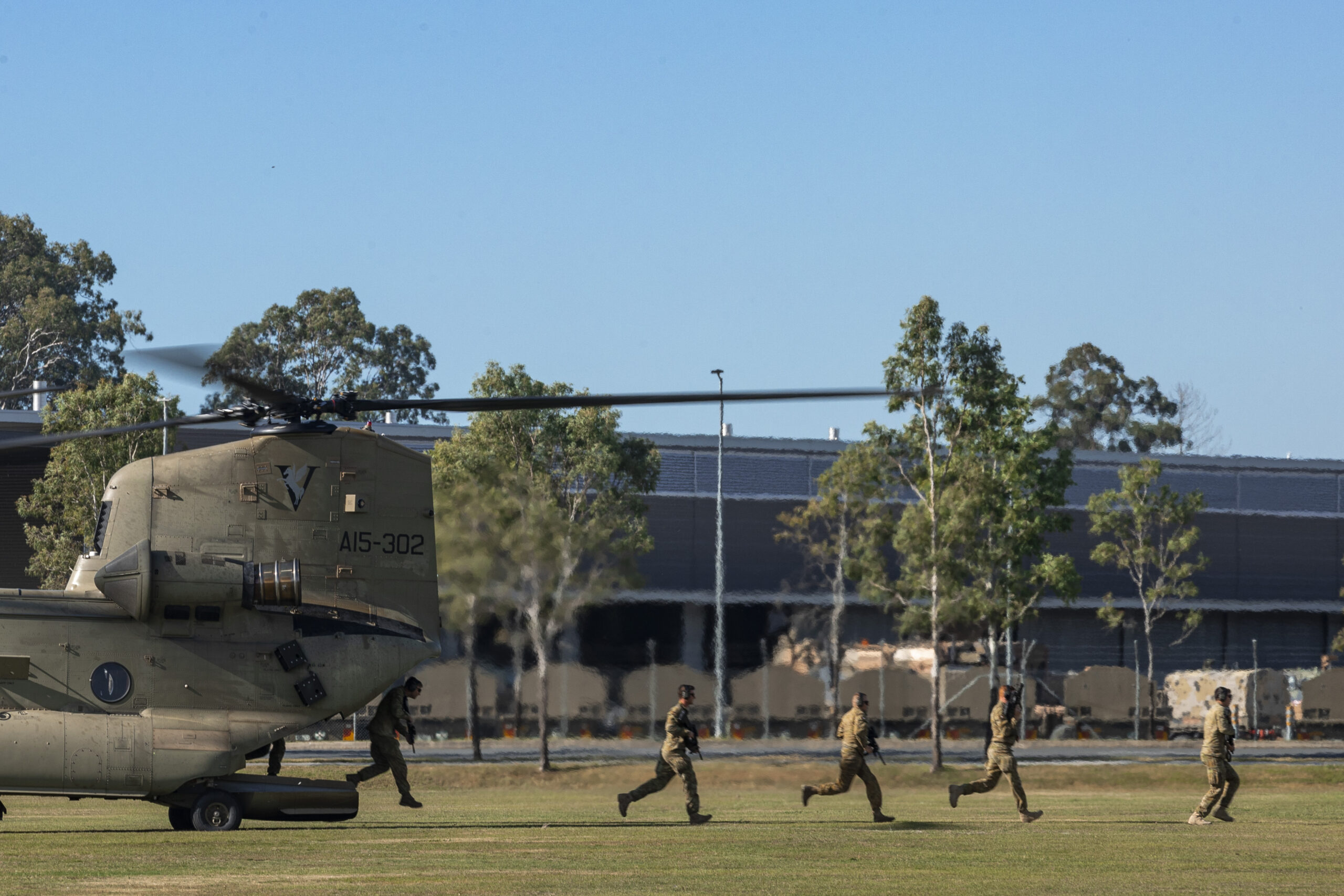 Australian Army riflemen from Alpha Company of the 8th/9th Battalion, The Royal Australian Regiment rehearse disembarking drills off a CH-47 Chinook during an Air Mobile Operation familiarisation and integration training exercise at Gallipoli Barracks, Brisbane. *** Local Caption *** Soldiers from Battle Group Ram, centred on, 8th/9th Battalion, The Royal Australian Regiment (8/9 RAR), took part in CH-47 Chinook integration training at Gallipoli Barracks, Brisbane, in June. The activity was supported by 5th Aviation Regiment. Soldiers conducted loading and offloading drills, refining their skills for air mobile operations. The training enhances Battle Group Rams readiness for major exercises such as Exercise Diamond Strike or operational deployments.