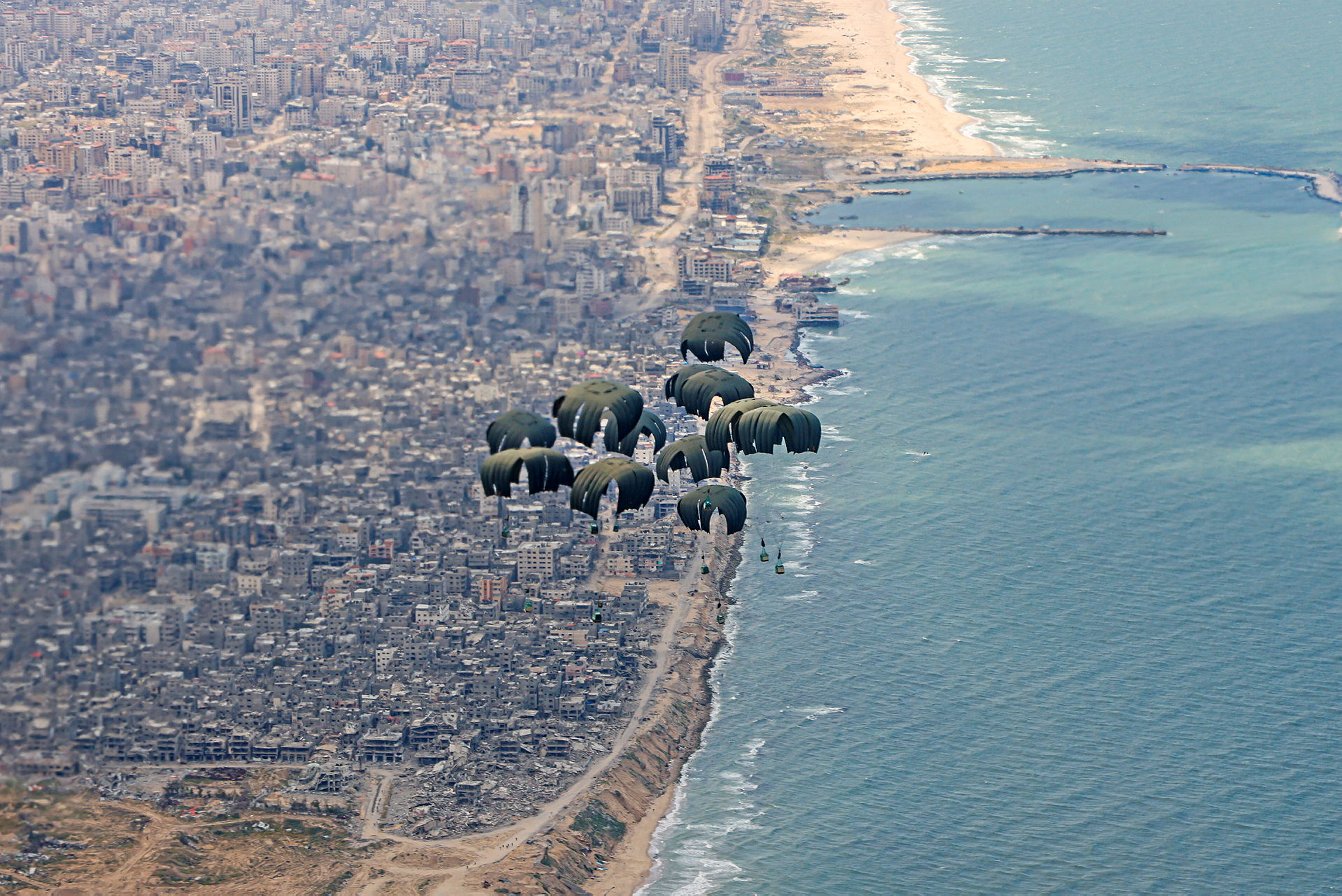 Image of humanitarian aid, seen here being airdropped over Gaza from a RAF A400M aircraft today (25/03/2024). The Royal Air Force airdropped over 10 tonnes of food supplies into Gaza for the first time on Monday, as part of international efforts to provide life-saving assistance to civilians. The aid, which consists of water, rice, cooking oil, flour, tinned goods and baby formula, will support the people of Gaza. The Defence Secretary authorised the airdrop following an assessed reduction in threat to the military mission and risk to civilians. An RAF A400M flew from Amman, Jordan to airdrop this aid along the northern coastline of Gaza, as part of the Jordanian-led international aid mission. UK personnel worked closely with the Royal Jordanian Air Force to plan and conduct this mission.
