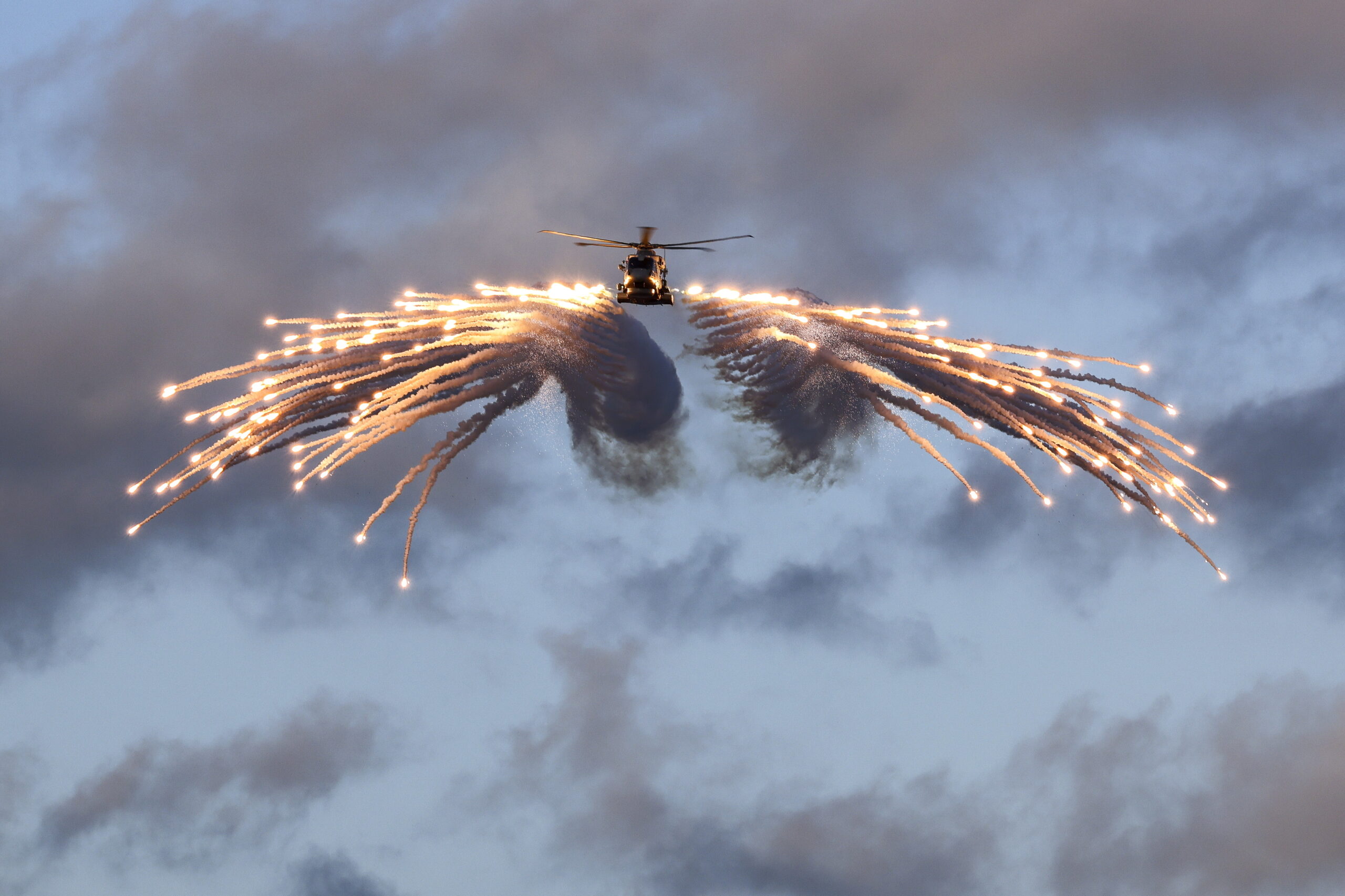 A Merlin helicopter from 820 Naval Air Squadron loaded and fired flares from HMS Prince of Wales, while embarked for Exercise Steadfast Defender. Flares are one element of the Defensive Aid Suite (DAS). The flares make up one portion of the DAS system, they are specifically designed to defeat Infra-Red seeking missiles (MANPADS). The aircraft carrier is taking part in Exercise Steadfast Defender. Exercise STEADFAST DEFENDER 2024 will be the largest NATO exercise in decades. NATO forces will be exercising across multiple regions and in multiple domains (maritime, land, air, space, and cyber). The vast scale of this exercise will occur over several months and over thousands of kilometres and will involve tens-of-thousands of Allied troops, all showcasing NATO capabilities to deter adversaries and defend allied territory.