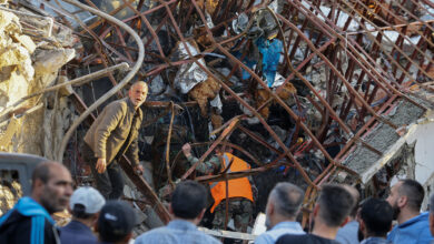 Emergency and security personnel inspect the rubble at the site of strikes which hit a building next to the Iranian embassy in Syria's capital Damascus