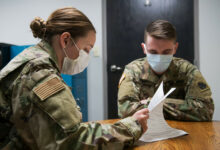 Airman Madison Hilton (left), a member of the Oklahoma Air National Guard's 138th Fighter Wing and Oklahoma Army National Guard Spc. Phillip Dimko (right), 120th Engineering Battalion, review documents for COVID-19 contact tracing on May 21, 2020 in Muskogee, Oklahoma. On May 21, there were eight members of the Oklahoma National Guard working contact tracing in Muskogee in order to advise individuals who may have been exposed to COVID-19 and provide them with necessary information on symptoms to look for, as well as testing sites if needed. (Oklahoma Air National Guard photo by Tech. Sgt. Rebecca Imwalle)