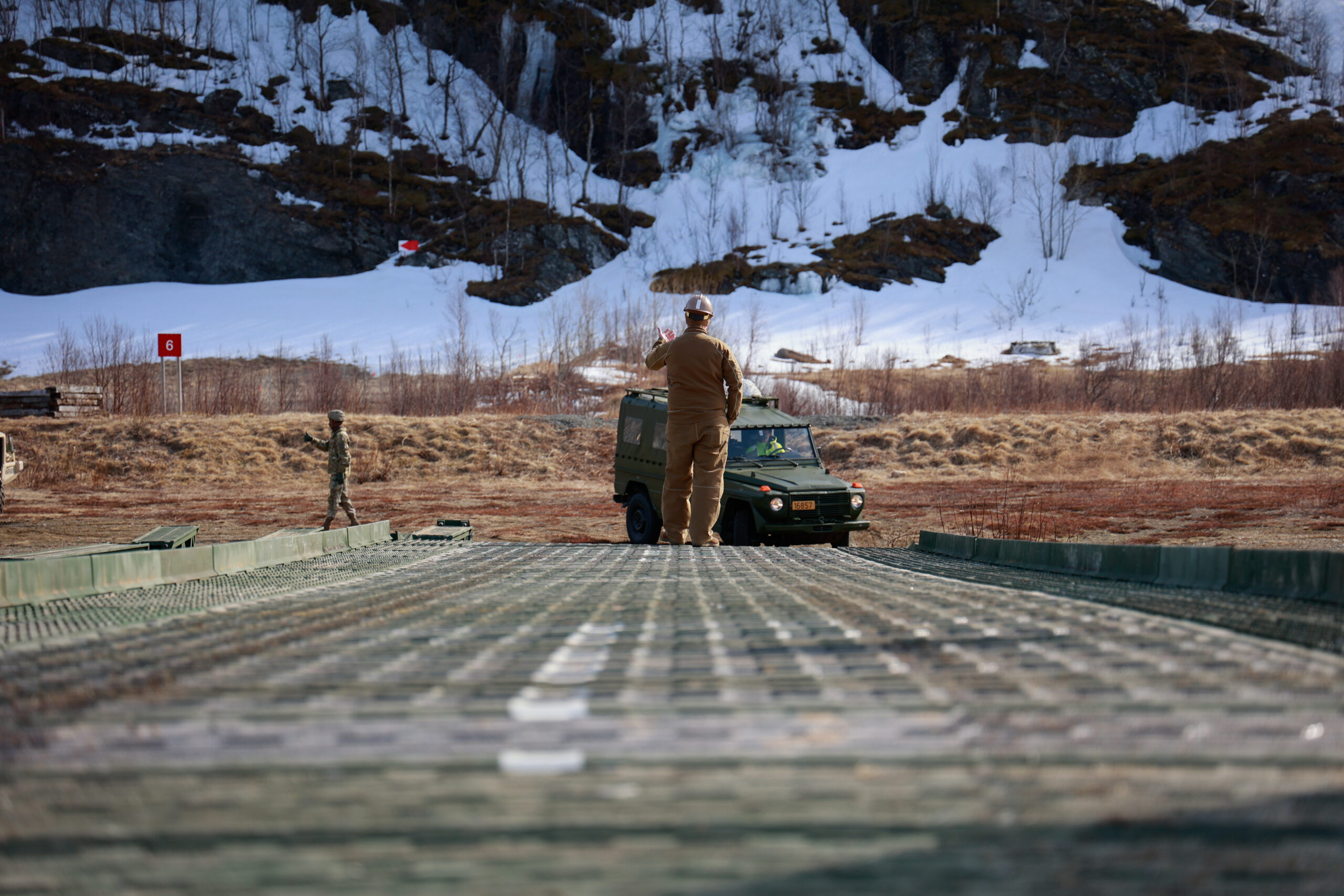 U.S. Navy Petty Officer 3rd Class Noah Sago, builder, Naval Mobile Construction Battalion 11, guides a Mercedes-Benz 240 GD across a medium girder bridge in Evenes, Norway, on April 26, 2024. As a part of DEFENDER 24, the U.S. Navy, U.S. Army, and Norwegian army stood up a medium girder bridge for the first time in Norway to test its functionality. Military exercises involving Allies and partner nations in the European theater remain an integral part of demonstrating readiness, interoperability, and capability. DEFENDER is the Dynamic Employment of Forces to Europe for NATO Deterrence and Enhanced Readiness, and is a U.S. European Command scheduled, U.S. Army Europe and Africa conducted exercise that consists of Saber Strike, Immediate Response, and Swift Response. DEFENDER 24 is linked to NATO’s Steadfast Defender exercise, and DoD’s Large Scale Global Exercise, taking place from 28 March to 31 May. DEFENDER 24 is the largest U.S. Army exercise in Europe and includes more than 17,000 U.S. and 23,000 multinational service members from more than 20 Allied and partner nations, including Croatia, Czechia, Denmark, Estonia, Finland, France, Germany, Georgia, Hungary, Italy, Latvia, Lithuania, Moldova, Netherlands, North Macedonia, Norway, Poland, Romania, Slovakia, Spain, Sweden, and the United Kingdom. (U.S. Army photo by Spc. Samuel Signor)