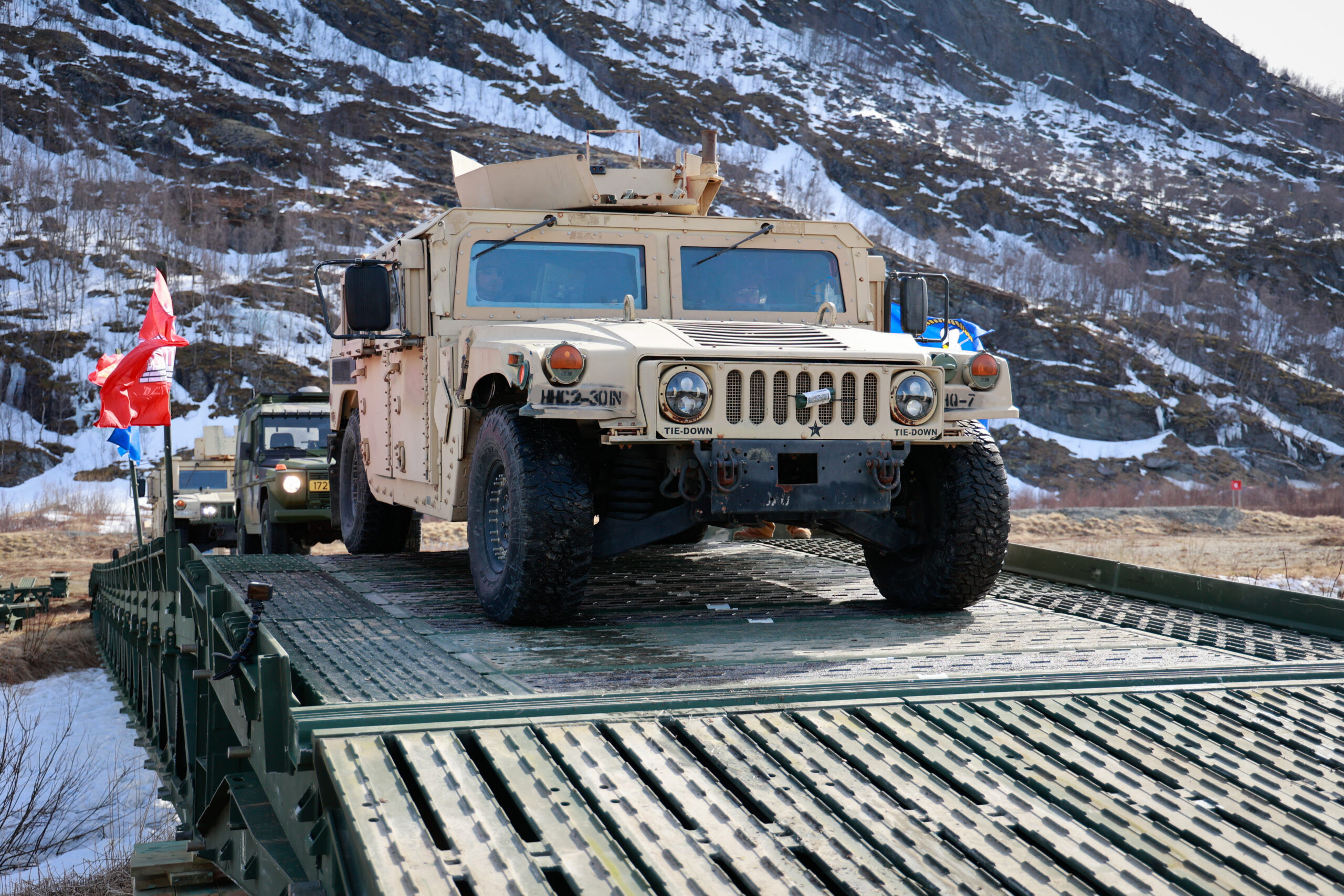 U.S. Army Soldiers from 3rd Brigade Combat Team, 10th Mountain Division, drive a humvee across a medium girder bridge in Evenes, Norway, on April 26, 2024. As a part of DEFENDER 24, the U.S. Navy, U.S. Army, and Norwegian army stood up a medium girder bridge for the first time in Norway to test its functionality. Military exercises involving Allies and partner nations in the European theater remain an integral part of demonstrating readiness, interoperability, and capability. DEFENDER is the Dynamic Employment of Forces to Europe for NATO Deterrence and Enhanced Readiness, and is a U.S. European Command scheduled, U.S. Army Europe and Africa conducted exercise that consists of Saber Strike, Immediate Response, and Swift Response. DEFENDER 24 is linked to NATO’s Steadfast Defender exercise, and DoD’s Large Scale Global Exercise, taking place from 28 March to 31 May. DEFENDER 24 is the largest U.S. Army exercise in Europe and includes more than 17,000 U.S. and 23,000 multinational service members from more than 20 Allied and partner nations, including Croatia, Czechia, Denmark, Estonia, Finland, France, Germany, Georgia, Hungary, Italy, Latvia, Lithuania, Moldova, Netherlands, North Macedonia, Norway, Poland, Romania, Slovakia, Spain, Sweden, and the United Kingdom. (U.S. Army photo by Spc. Samuel Signor)