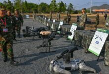 Cambodian Armed Forces commanders inspect drones and a machine gun equipped robot battle "dog" displayed in front of Chinese soldiers during the Cambodian-Chinese Dragon Gold 2024 drill